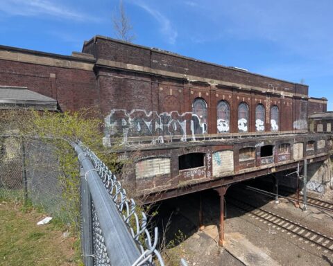 The old train station looming above active train tracks at the Pawtucket/Central Falls city line remains an expensive albatross.