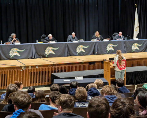 North Smithfield High School sophomore Quinn Crowshaw asks visiting Rhode Island Supreme Court justices on the stage a question about preliminary injunctions on Thursday, April 2, 2026.