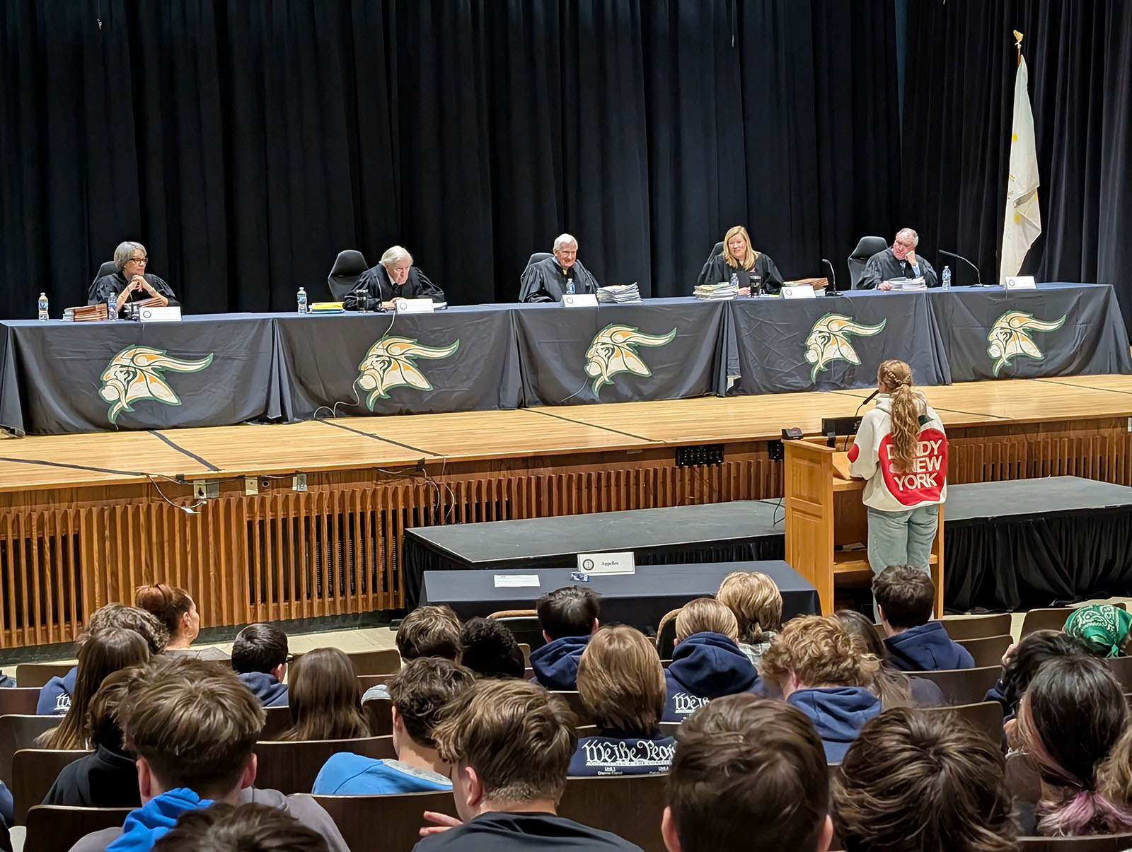 North Smithfield High School sophomore Quinn Crowshaw asks visiting Rhode Island Supreme Court justices on the stage a question about preliminary injunctions on Thursday, April 2, 2026.