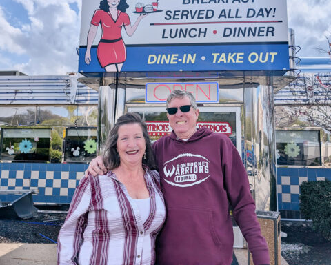 Sandy Boucher and Marc Berthelette stand outside of Patriots Diner in Woonsocket.
