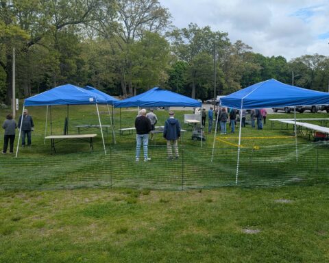 Volunteers set up for Saturday's sale in record time Friday afternoon.