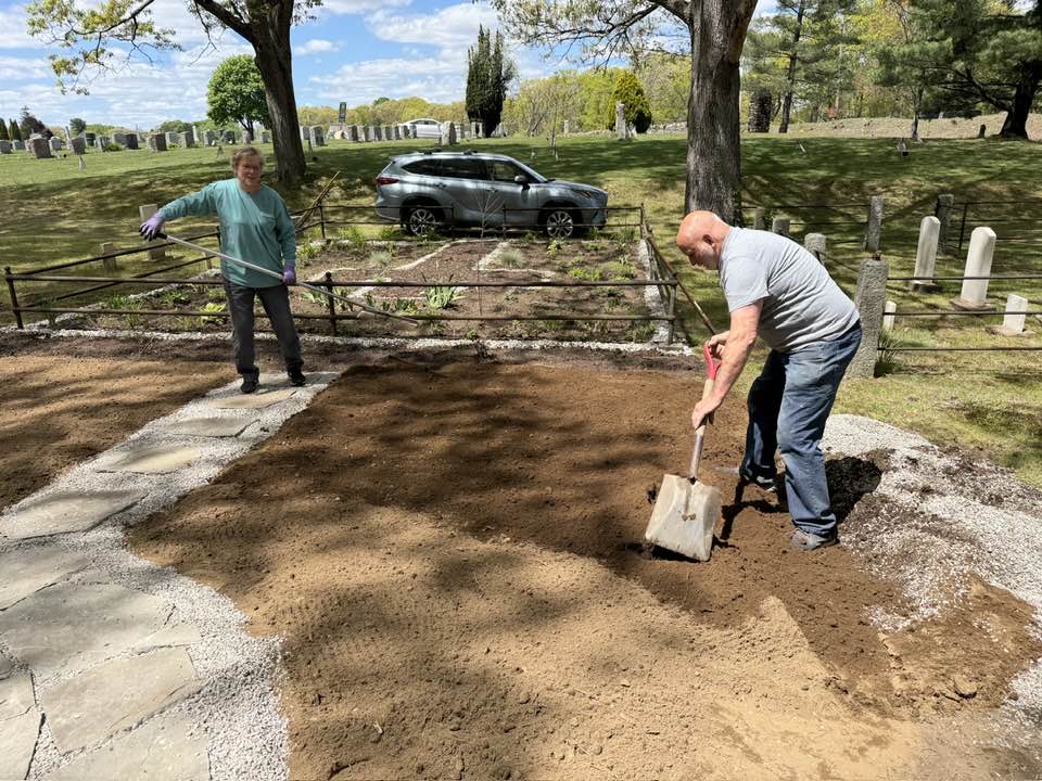 Liane Jalette and Steve Biron spread soil on Tuesday.