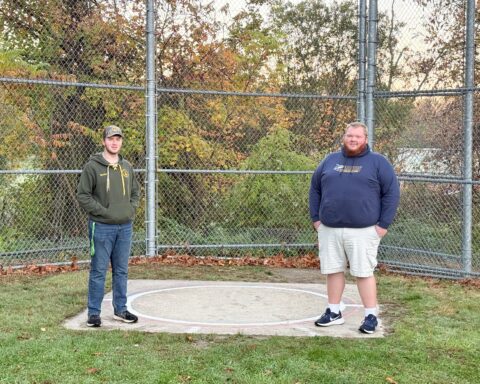Nathan Webber and Ricky Goodreau stand on the old throwing circle at Tucker Field.