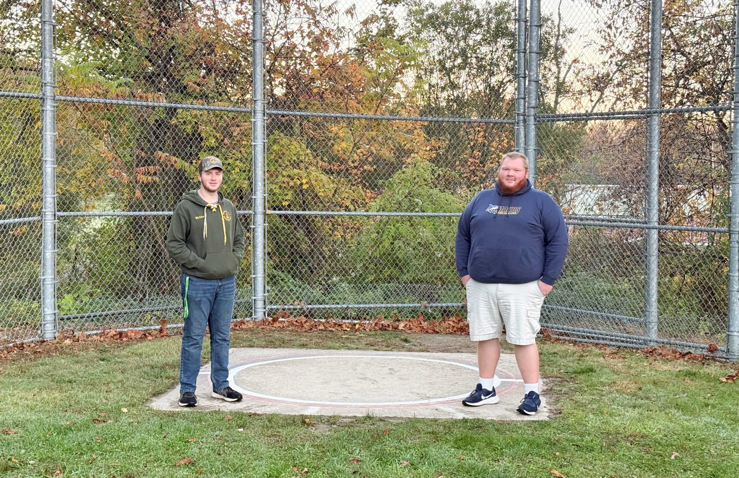 Nathan Webber and Ricky Goodreau stand on the old throwing circle at Tucker Field.