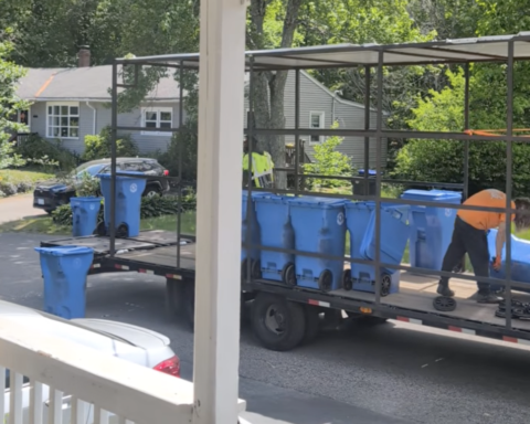 Workers collect bins in the Monastery Heights neighborhood.