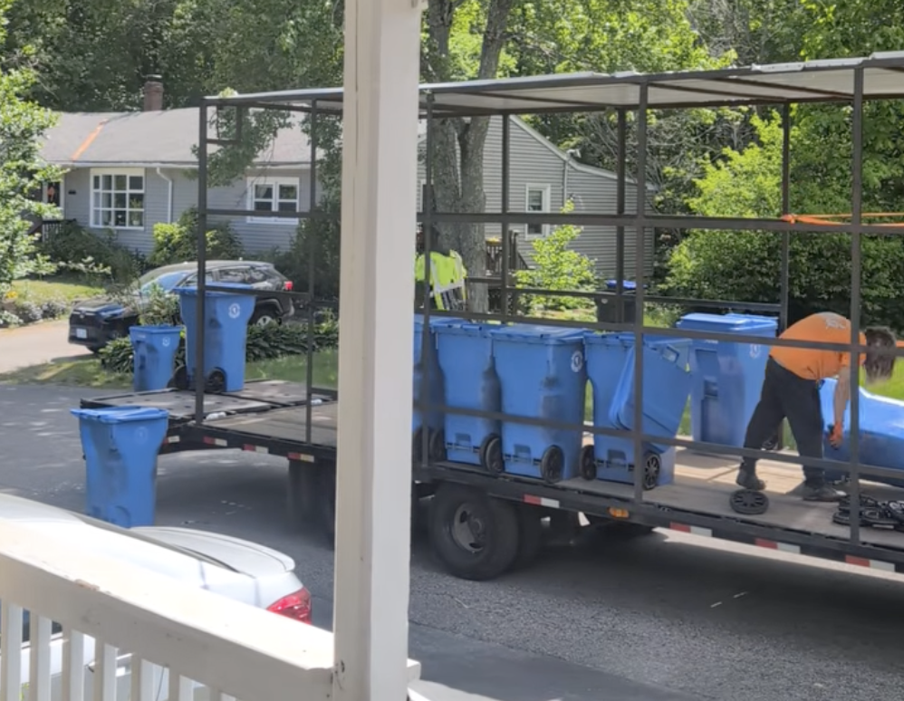 Workers collect bins in the Monastery Heights neighborhood.