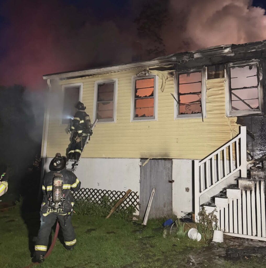 Firefighters battle a fire at a home on Garvin Street Monday evening