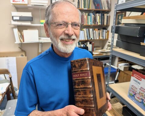 Al Menard holds the Bible with its new binding.