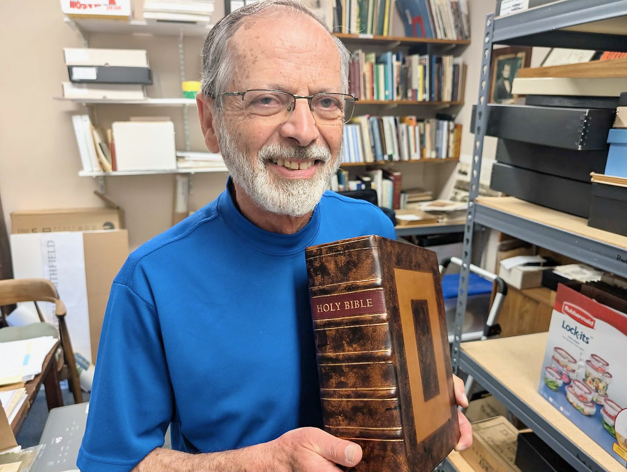 Al Menard holds the Bible with its new binding.