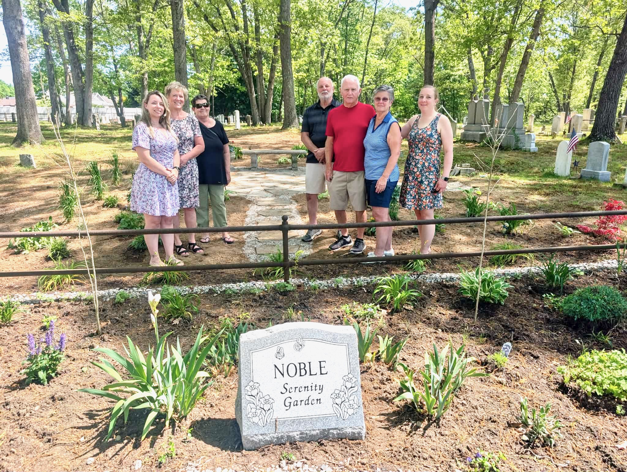 Cindi Noble, second from right, gathers with friends, family, staff members, and volunteers at the new serenity garden created in her honor.