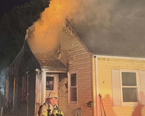 Firefighters battle a fire at a home on Garvin Street Monday evening.