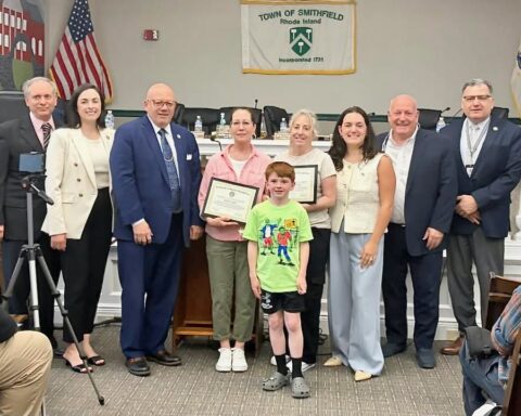 Smithfield Town Council members and Town Manager Robert Seltzer gather with Renee Grey, Caroline King, and Braxton Howard, all at center, for a photo at the most recent council meeting. Town officials are, from left, Michael Iannotti, Rachel Toppi, John Tassoni Jr., Angelica Bovis, Thomas Winfield, and Seltzer.
