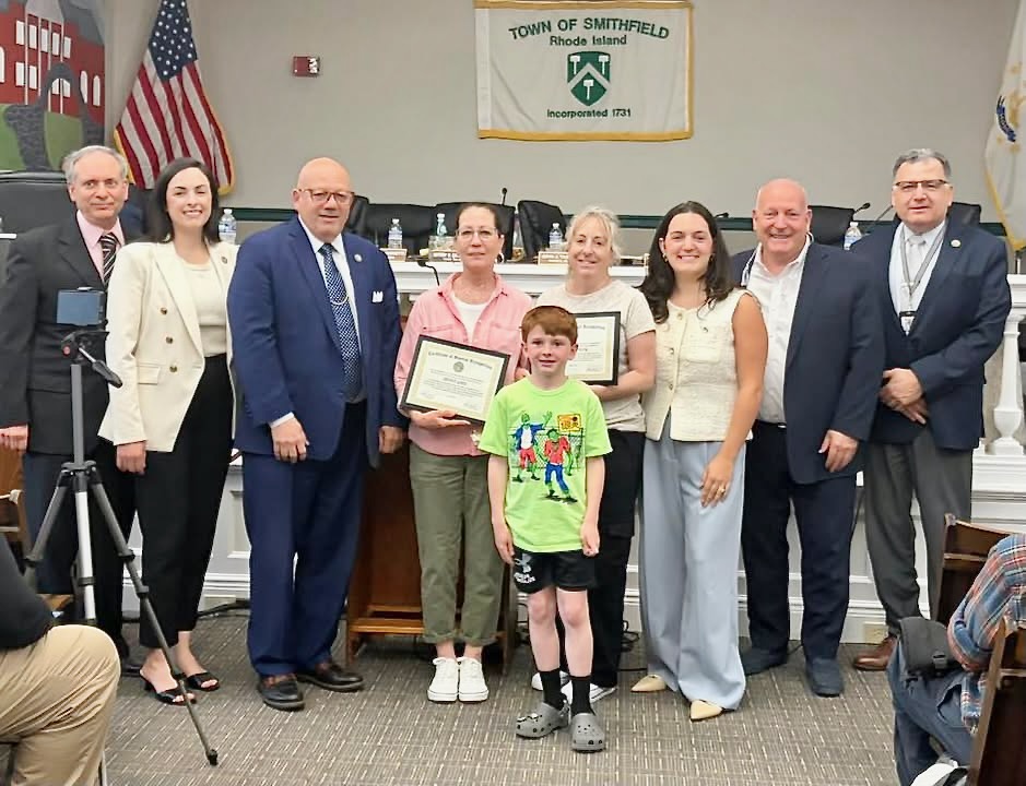 Smithfield Town Council members and Town Manager Robert Seltzer gather with Renee Grey, Caroline King, and Braxton Howard, all at center, for a photo at the most recent council meeting. Town officials are, from left, Michael Iannotti, Rachel Toppi, John Tassoni Jr., Angelica Bovis, Thomas Winfield, and Seltzer.
