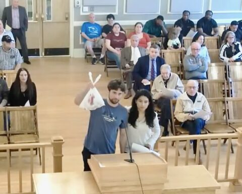 Felton Messina holds up a bag of golf balls at the most recent Town Council meeting.