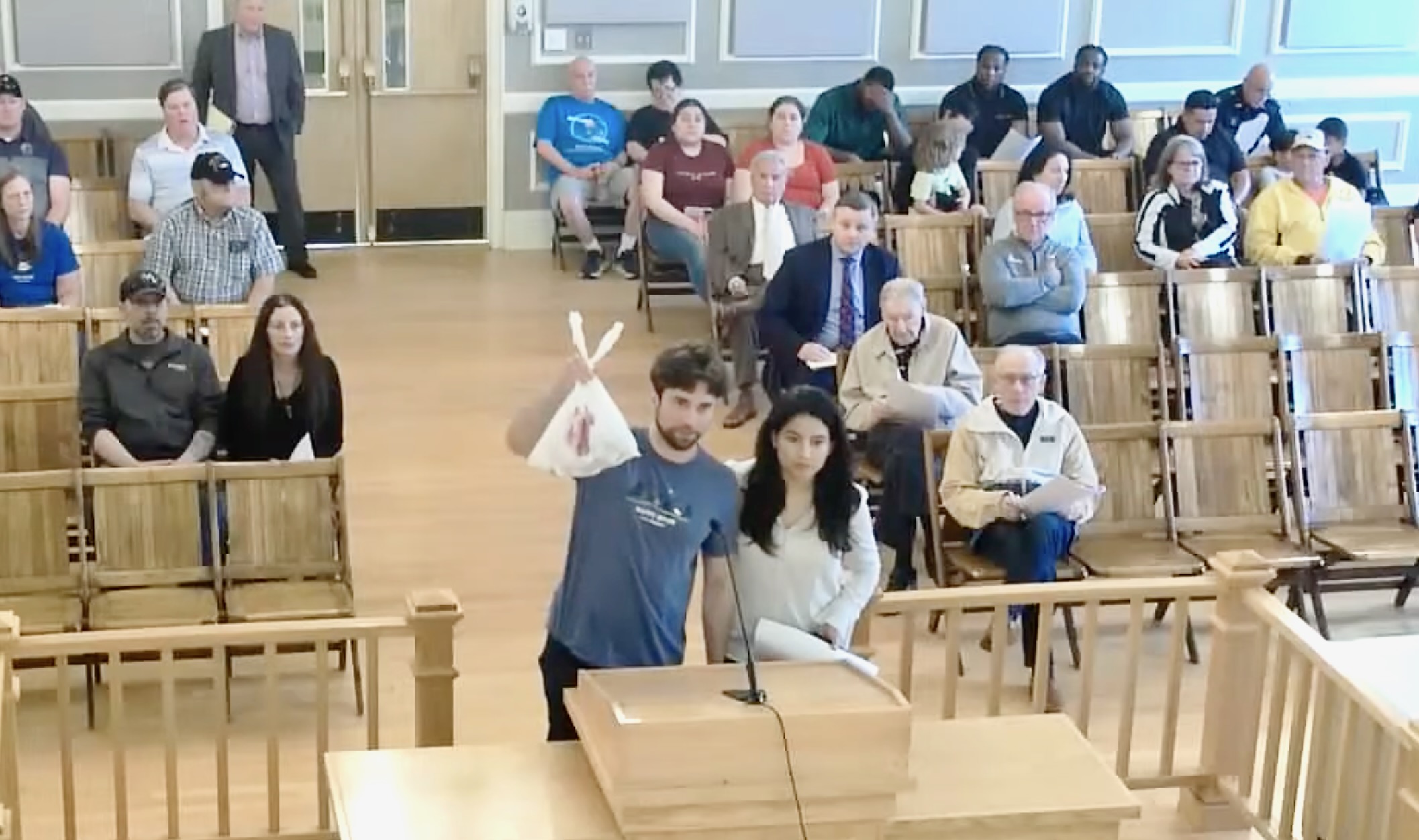 Felton Messina holds up a bag of golf balls at the most recent Town Council meeting.