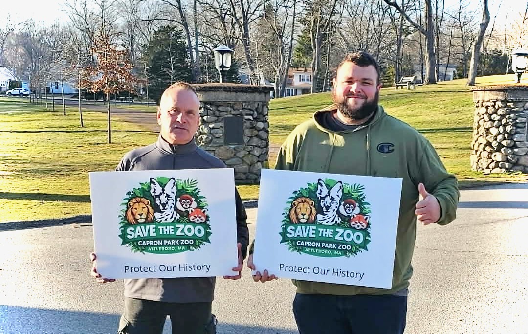 Bob Bassill, vice president of the Capron Park Zoological Society, and Nick Lavoie, president of the group, with their famous signs.