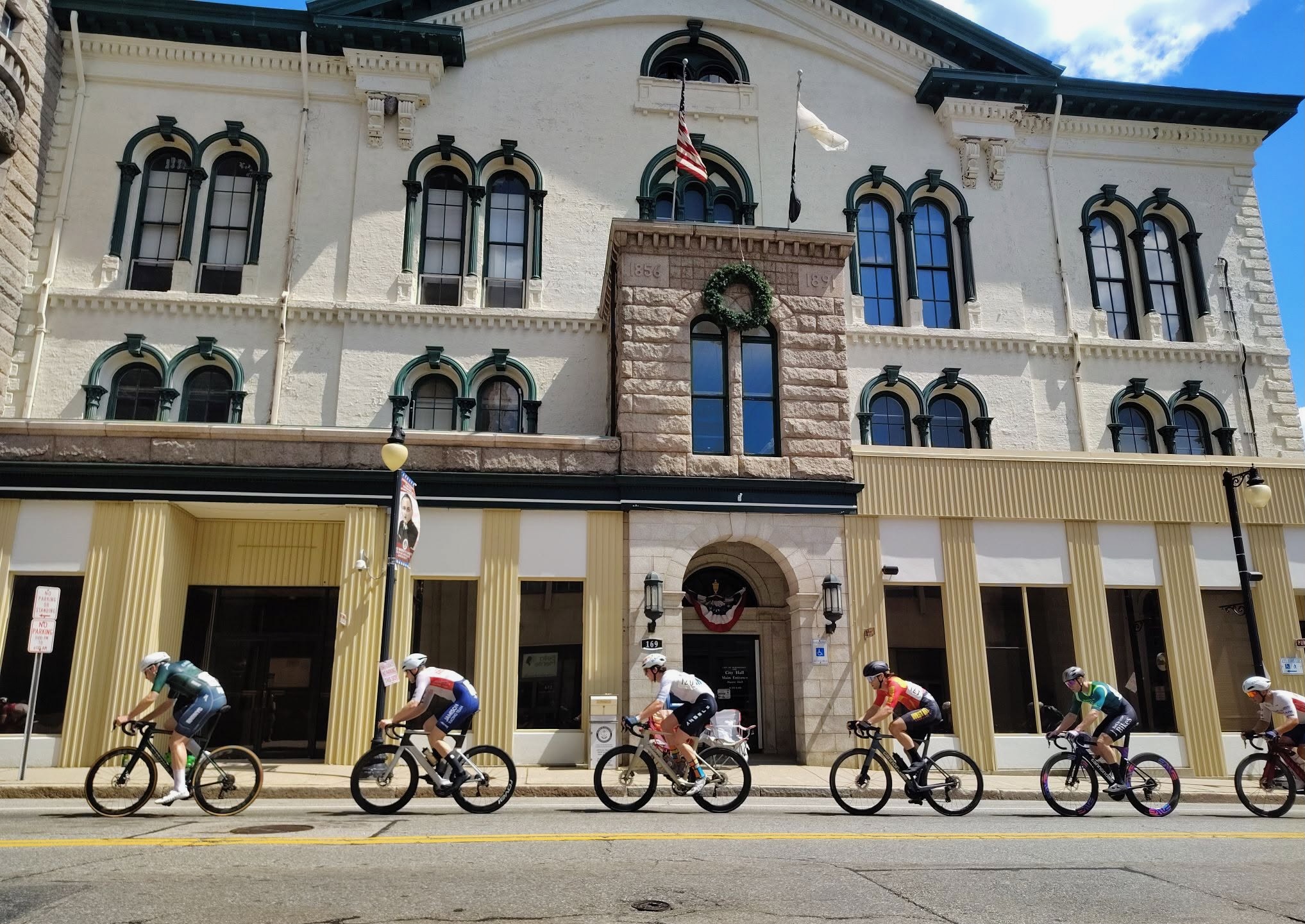 Racers pass Woonsocket City Hall on Sunday.