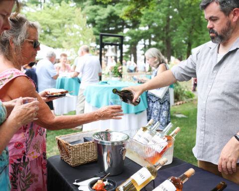 Guests enjoy dessert wine poured by Sakonnet Vineyard during the 2025 Summer Soirée. (Photo by Laura Kilgus of 9ten Photography)