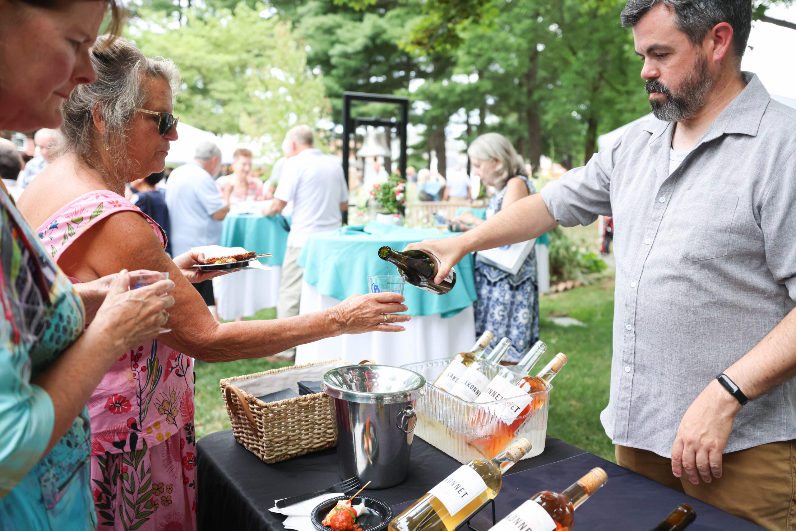 Guests enjoy dessert wine poured by Sakonnet Vineyard during the 2025 Summer Soirée. (Photo by Laura Kilgus of 9ten Photography)
