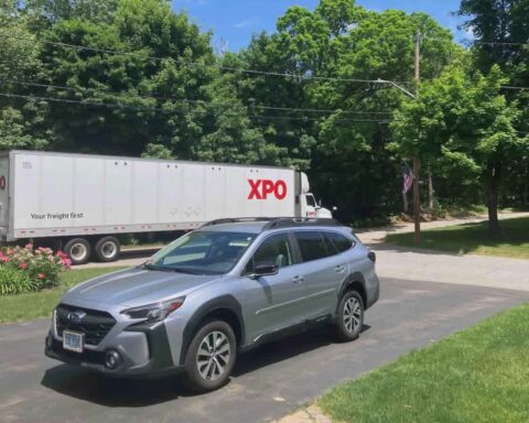 A large truck moves down North Attleboro Road.