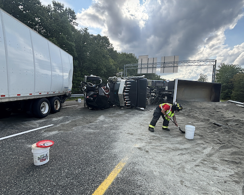 Crews used sand from the overturned truck to prevent spilling fuel from entering the surrounding area following Friday's crash.