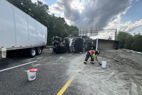 Crews used sand from the overturned truck to prevent spilling fuel from entering the surrounding area following Friday's crash.