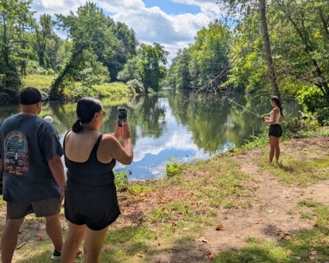 A teen from Central Falls practices fishing for the first time. (photo by Ethan Shorey)