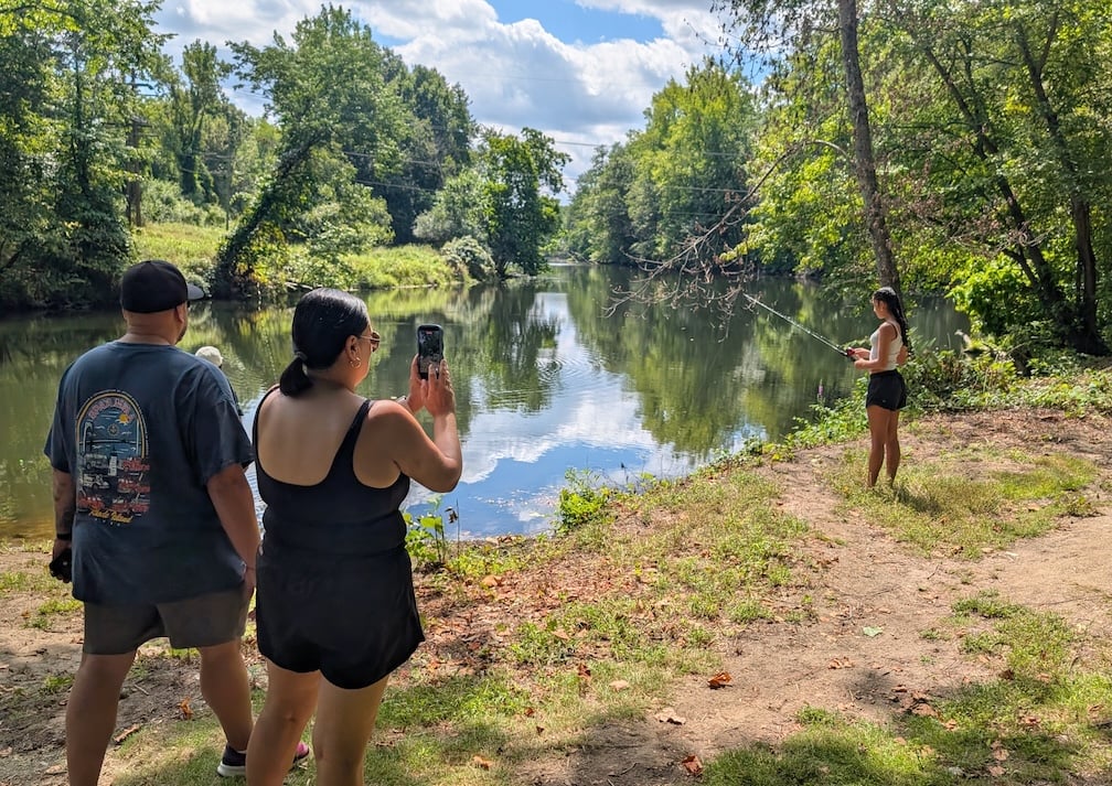 A teen from Central Falls practices fishing for the first time. (photo by Ethan Shorey)