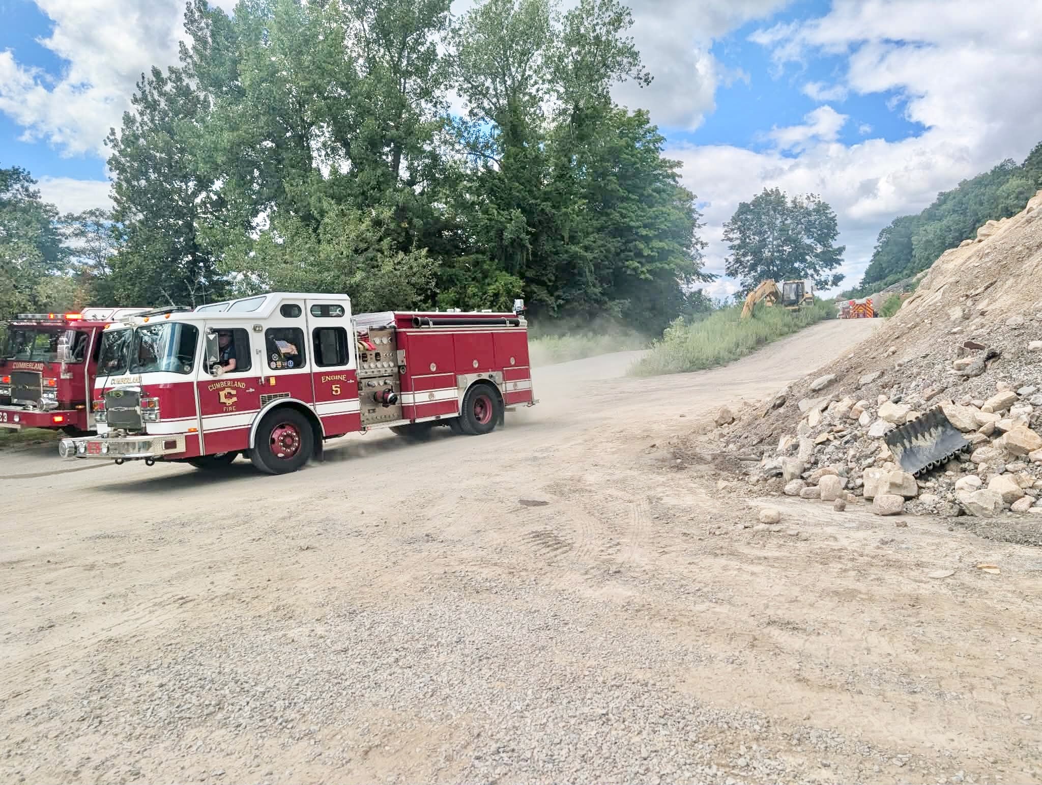 A Cumberland Fire crew leaves the scene of the overturned dump truck at the quarry on Tuesday.