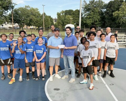 At Evans Park recently, Justin Conrad, center left, presented a check to local youth sports.