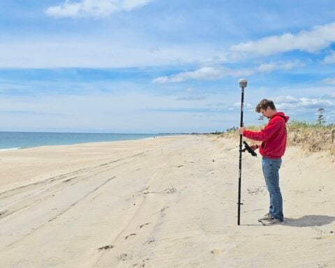 Jake Harrington using the real-time kinematic global positioning system for a beach survey.
