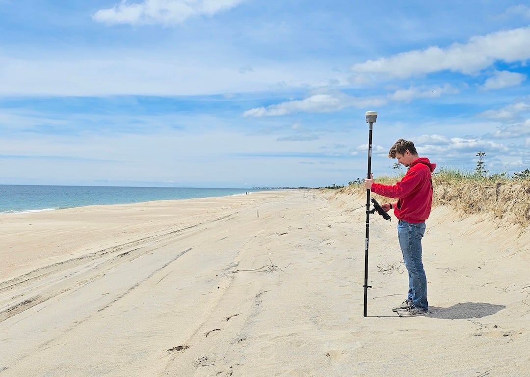 Jake Harrington using the real-time kinematic global positioning system for a beach survey.