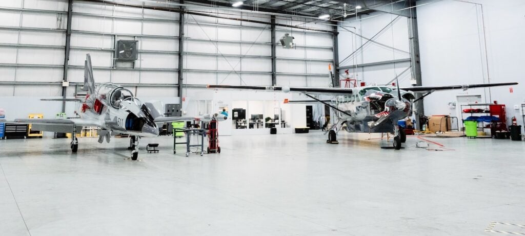 Merlin's Cessna 208 Caravan and L-39 Albatros at the North Central State Airport hangar.