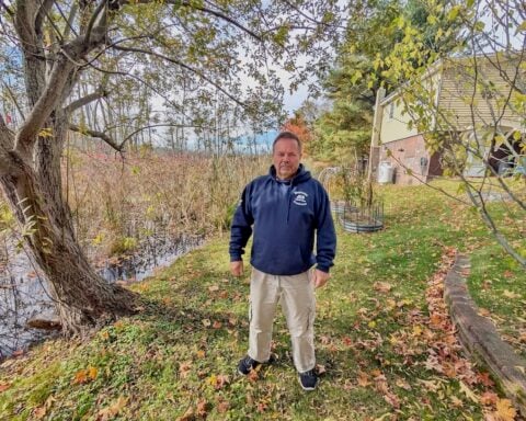 Steve Bacon stands in the narrowing stretch of land between his home on Nate Whipple Highway and the expanding Sneech Pond Brook. (Insider photos by Ethan Shorey).