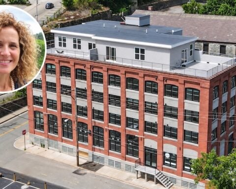 Former Mayor Lisa Baldelli-Hunt and the luxury apartment building at 43 Railroad St. in Woonsocket.